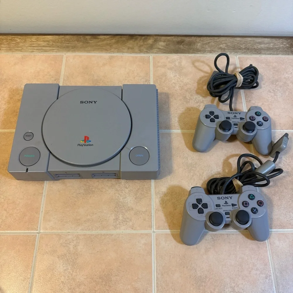 Sony Gray PlayStation Console with Two Wired Gray Controllers